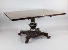 A large early Victorian mahogany tilt top breakfast table, with rectangular top, on octagonal column