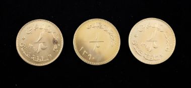 Three cased 1970`s Omani gold half rial gold coins.