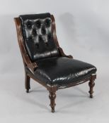 A Victorian walnut chair, with black leather buttoned upholstery, on turned front legs