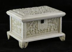 A Chinese export ivory casket, late 19th century, the cover and sides carved in high relief with