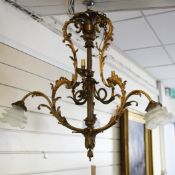 A 19th century French gilt brass six branch ceiling light, with acanthus scrolls and six opaque