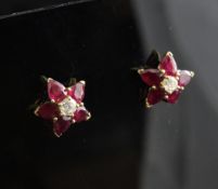 A pair of 18ct gold, ruby and diamond set flowerhead ear studs.