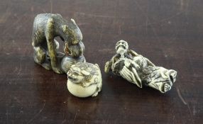 Three Japanese netsuke, early 20th century, two of stag horn, the first carved as a lion-dog