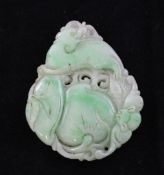 A Chinese white and apple green jadeite pendant carved in relief with a mythical beast, a peach