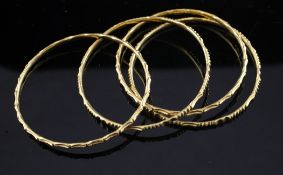 A set of four middle eastern gold child`s bangles, unmarked, 31.4 grams.