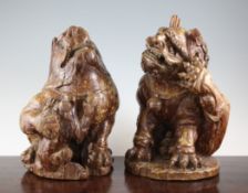 A pair of South East Asian carved and painted lion-dogs, largest 15in.