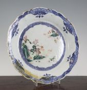 A Chinese famille rose petal lobed dish, Qianlong period, painted with pagodas in a river