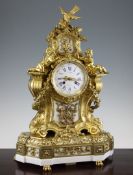 A 19th century French ormolu and white marble mantel clock, surmounted with a bird and putti, the