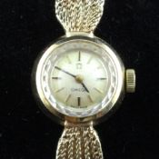 A lady`s early 1960`s 9ct gold Omega wrist watch, with baton numerals, on 9ct gold Omega mesh link