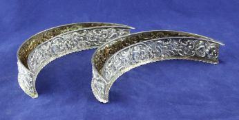A pair of late Victorian repousse silver crescent shaped posy troughs, by William Comyns,
