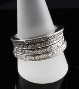 A modern 18ct white gold and diamond dress ring, with four rows of small brilliant cut diamonds,