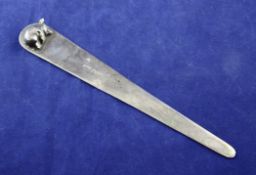 A George V silver letter opener, the handle surmounted with a sleeping pig, Andrew Barrett & Sons,