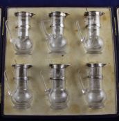A cased set of six George V silver mounted glass whisky tots, by Asprey & Co Ltd, of baluster