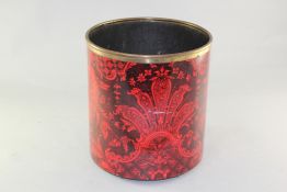 A Fornasetti brass mounted enamel waste paper bin, decorated with an elaborate foliate design in