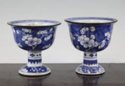 A near of pair of Chinese blue and white stem cups, 18th century, the bowls painted with prunus