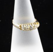 A George V 18ct gold and graduated five stone diamond ring, size M.