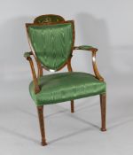An Edwardian Sheraton revival painted satinwood chair, with shield shaped back on tapered square