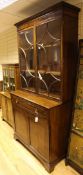 A George III mahogany bookcase, with two astragal glazed doors above a drawer and two cupboard,
