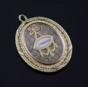 A fine early 19th century French two colour gold memorial pendant locket, inset with an ivory plaque