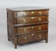 An early 18th century oak split section chest, of four long drawers, on stile feet, 2ft 11.5in. x