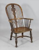 A 19th century yew and ash Windsor chair, with saddle seat, on turned legs with crinoline stretcher