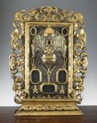 A 19th century Florentine carved giltwood and gesso reliquary, the central panel with a pouch and