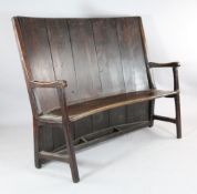A George III pine and elm curved settle, on moulded legs, 4ft 1.5in. x 4ft 8in. - a.f.