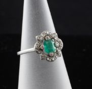 A 1930`s platinum, emerald and diamond cluster ring, size J