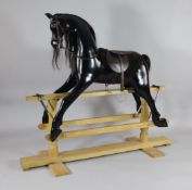 A modern ebonised rocking horse, on pine stand, with named label `Gabriella` dated 5th May 1995,