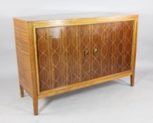 A Gordon Russell rosewood and mahogany side cabinet, design number R407, with helix pattern doors on