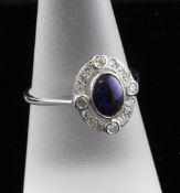 An 18ct white gold and black opal doublet oval cluster ring, size O.