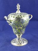 A Victorian pierced silver two handled pedestal sugar vase and cover, with engraved foliate