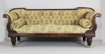 A William IV carved mahogany scroll end settee, with button back armorial upholstery on turned and