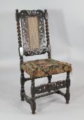 A late 17th century Carolean carved walnut chair, with crown cresting rail and caned back, on spiral