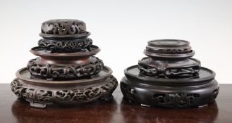 Six Chinese carved wood stands and a similar cover, largest 9.5in.