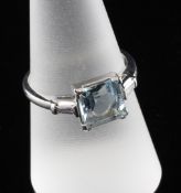 A platinum, aquamarine and diamond ring, with square cut aquamarine and diamond set shoulders,