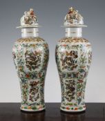 A pair of Chinese famille rose `butterfly` baluster vases and covers, late 19th / early 20th