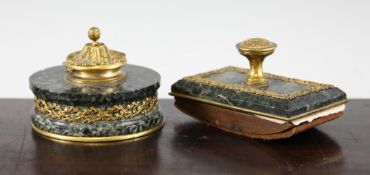 An early 19th century French ormolu mounted stained green marble circular inkwell and matching