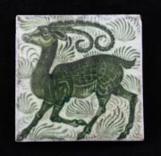 A William de Morgan `antelope and foliage` tile, c.1900, decorated in green on a white ground,
