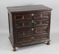 A Jacobean oak chest, fitted four graduated drawers with geometric moulded fronts, raised on later