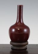 A Chinese flambe glazed bottle vase, with attached rosewood stand, 9.25in.