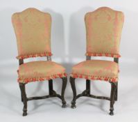 A mid 18th century Italian pair of walnut chairs, with stuffed arched backs, stuffed serpentine