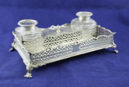 A Victorian silver rectangular inkstand, with pierced silver gallery and serpentine rim, with pen