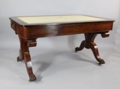 An early Victorian mahogany writing table, in manner of Straherne, with three drawers, on outswept