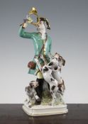 A Meissen group of a huntsman and three hounds, 20th century, he wearing a green coat and holding