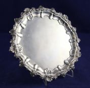 An Edwardian silver salver, with shell and floral scroll border, on acanthus leaf scroll feet,
