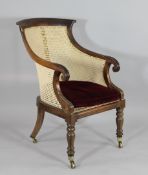 A George IV carved rosewood bergere tub chair, with scroll end arms, on turned and carved legs