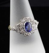 An 18ct gold sapphire and diamond oval cluster ring, size Q.