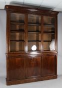 A Victorian mahogany bookcase, with three glazed doors enclosing adjustable shelves over three