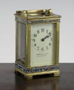 An Edwardian gilt brass carriage timepiece, with champleve enamel banded decoration and arabic dial,